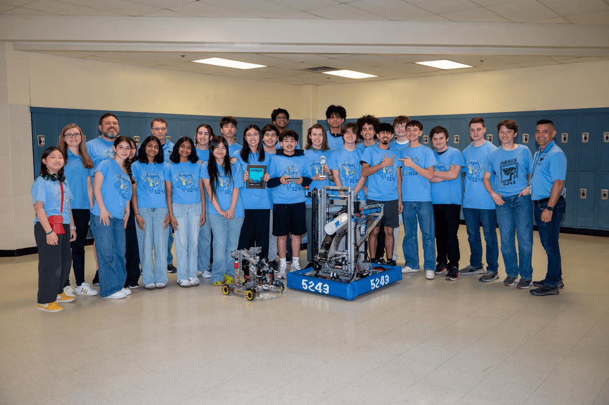 Team photo with robotics display