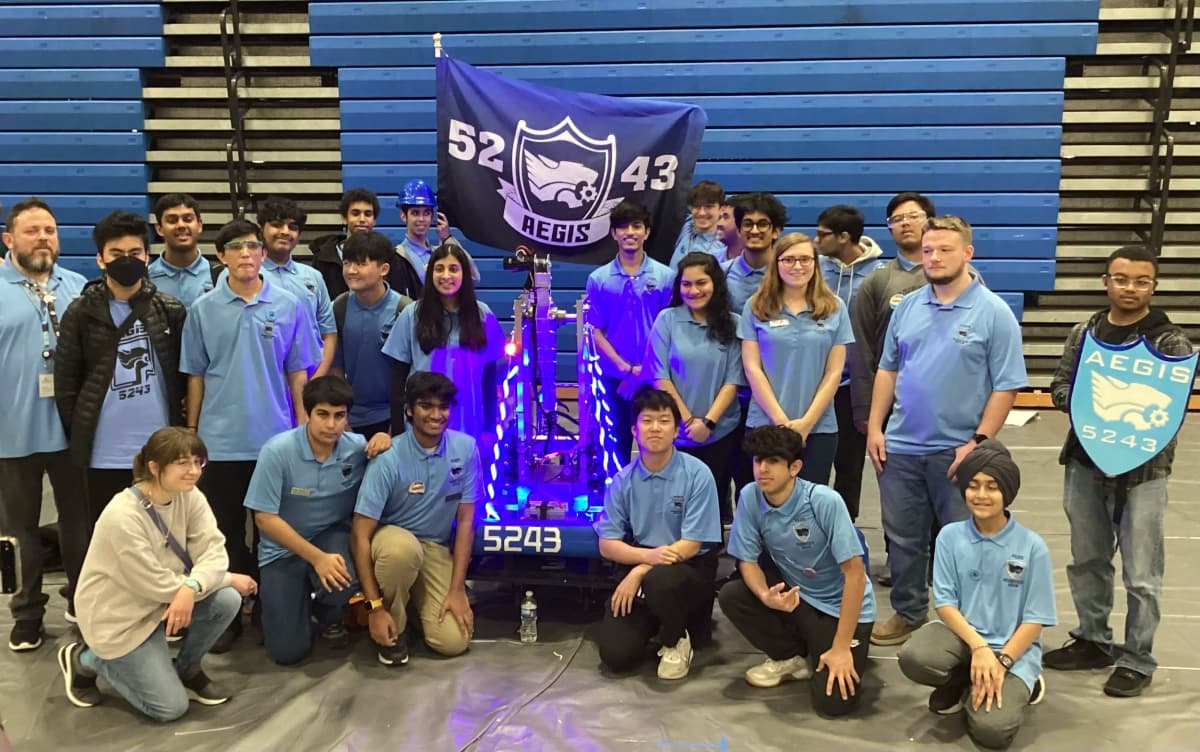 Team photo with robotics display
